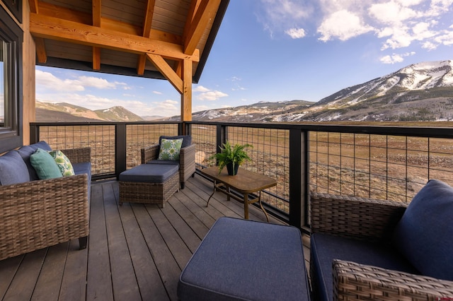 wooden deck featuring a mountain view