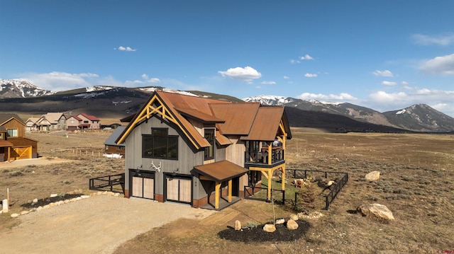 view of front facade with a mountain view and a balcony