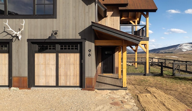 doorway to property featuring a mountain view and a balcony