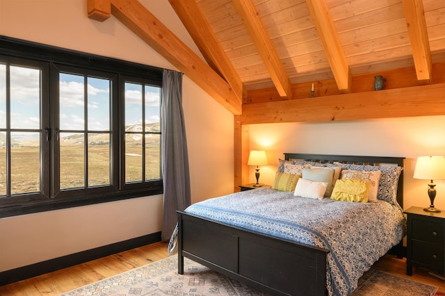 bedroom with wood ceiling, lofted ceiling with beams, and wood finished floors