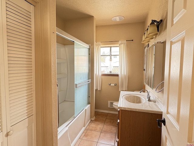 full bath with a textured ceiling, tile patterned flooring, vanity, toilet, and shower / bath combination with glass door