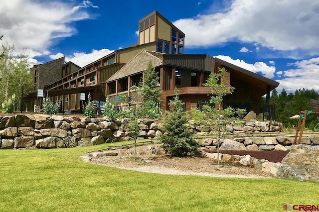 back of property featuring a lawn