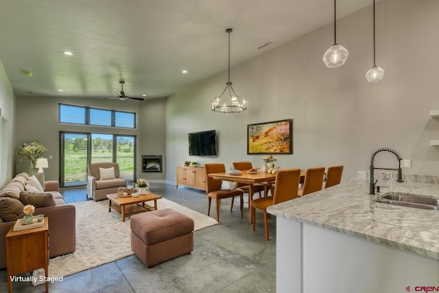 2785 Rock Rd Unit A, Pagosa Springs, CO 81147 - living room with concrete flooring, high vaulted ceiling, recessed lighting, a ceiling fan, and baseboards