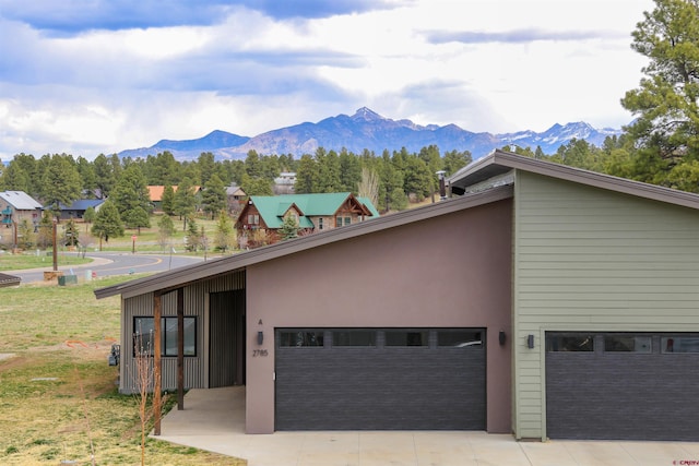 2785 Rock Rd Unit A, Pagosa Springs, CO 81147 - exterior space with concrete driveway, an attached garage, and a mountain view
