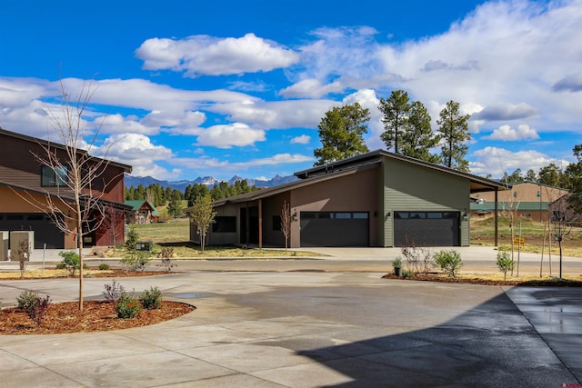 2785 Rock Rd Unit A, Pagosa Springs, CO 81147 - view of front of home featuring a garage, a mountain view, and driveway