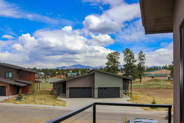 2785 Rock Rd Unit A, Pagosa Springs, CO 81147 - view of front of house featuring a detached garage, a mountain view, and a residential view