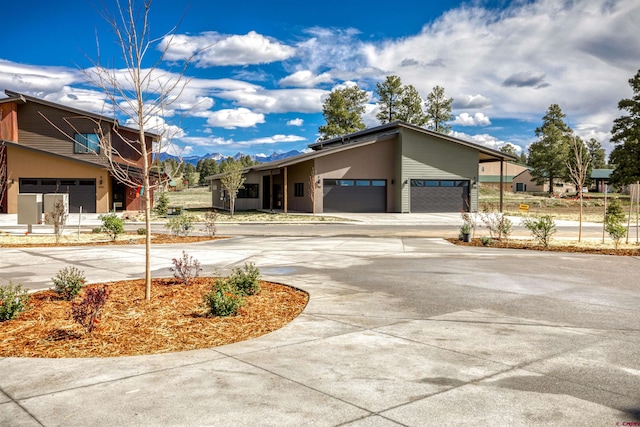 2785 Rock Rd Unit A, Pagosa Springs, CO 81147 - view of front of home featuring stucco siding, curved driveway, and a garage