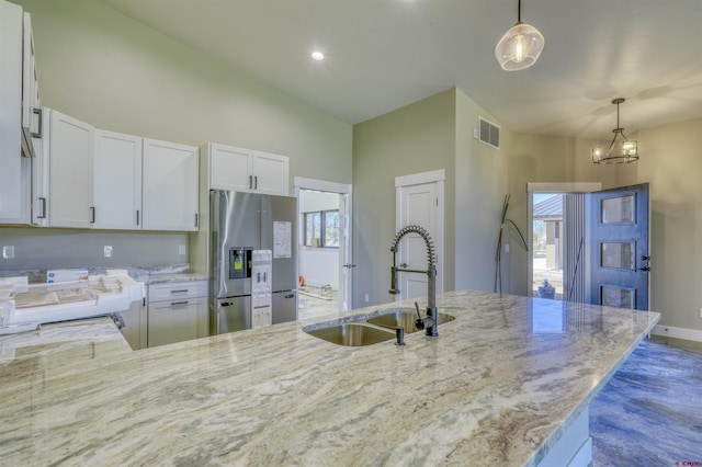 2785 Rock Rd Unit A, Pagosa Springs, CO 81147 - kitchen featuring visible vents, a sink, light stone counters, and stainless steel fridge