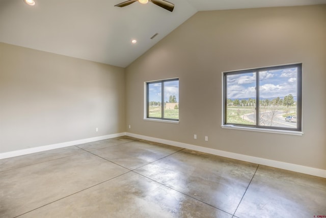 empty room with baseboards, a ceiling fan, high vaulted ceiling, and finished concrete floors