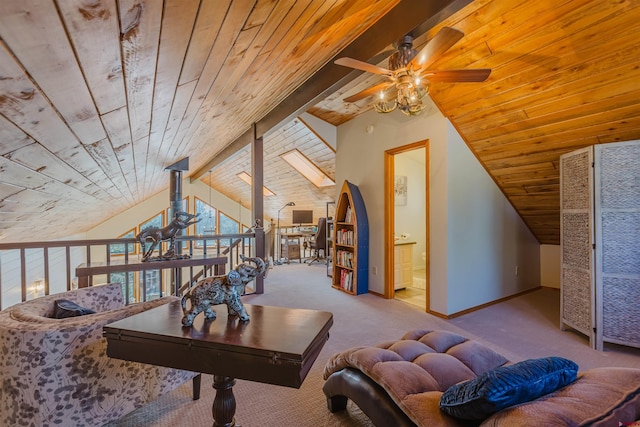 interior space featuring a ceiling fan, baseboards, lofted ceiling with beams, and wooden ceiling
