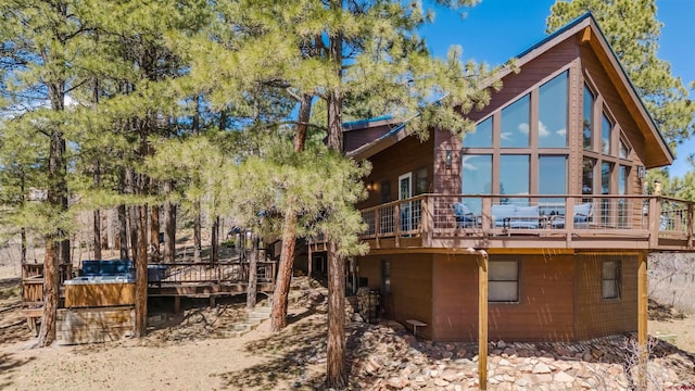 back of house featuring a wooden deck
