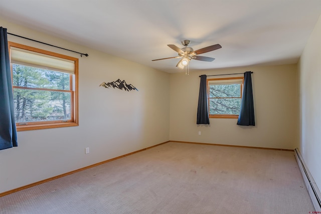 unfurnished room with a healthy amount of sunlight, a baseboard radiator, light carpet, and ceiling fan