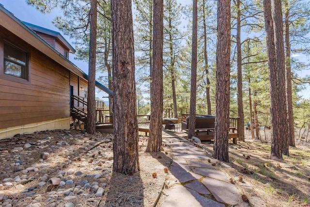 view of yard with a wooden deck and a hot tub