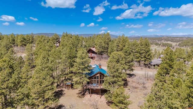 bird's eye view featuring a forest view and a mountain view