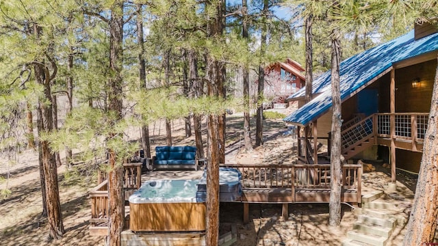 view of yard featuring a hot tub, a deck, and stairs