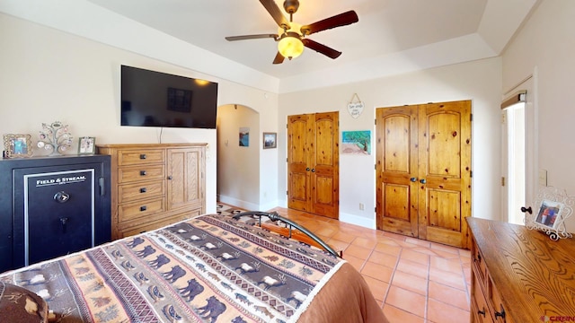 18812 Rd 27, Dolores, CO 81323 - bedroom with light tile patterned floors, arched walkways, baseboards, and a ceiling fan