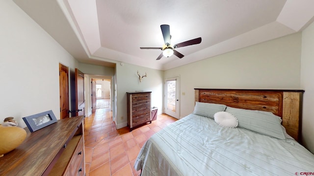 18812 Rd 27, Dolores, CO 81323 - bedroom with baseboards, access to outside, a tray ceiling, a ceiling fan, and light tile patterned floors
