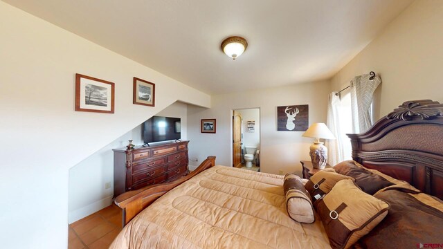 18812 Rd 27, Dolores, CO 81323 - tiled bedroom featuring baseboards and ensuite bath