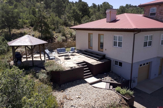 18812 Rd 27, Dolores, CO 81323 - view of property exterior with an outdoor hangout area, a patio, a chimney, and stucco siding