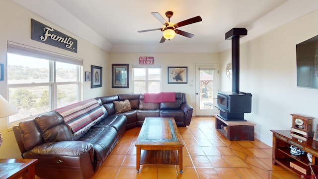 18812 Rd 27, Dolores, CO 81323 - living area with plenty of natural light, a ceiling fan, light tile patterned floors, and a wood stove
