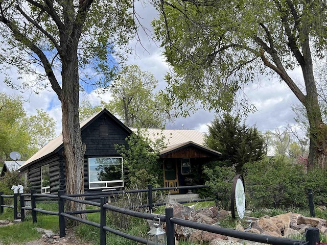 view of front of property with an exterior structure and log siding