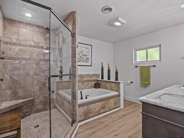 bathroom featuring baseboards, a shower stall, wood finished floors, visible vents, and a bath