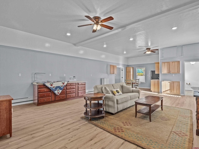 living room featuring light wood-style floors, a baseboard radiator, baseboard heating, recessed lighting, and a ceiling fan