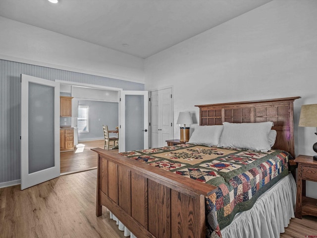 bedroom with baseboards and light wood-style flooring