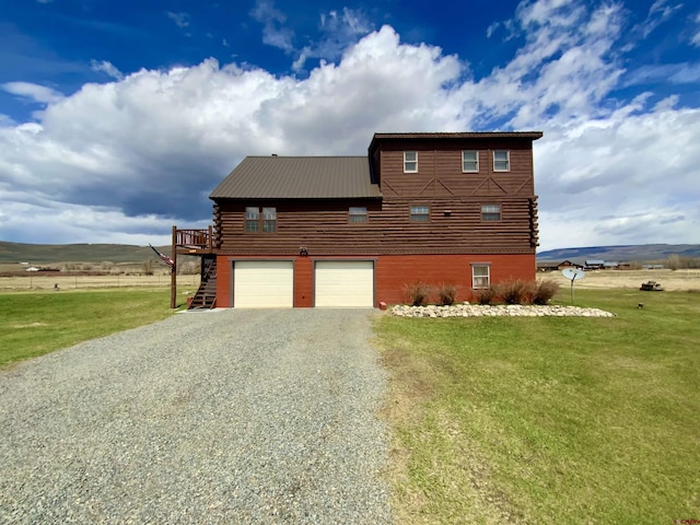 409 Sierra Vista Way, Gunnison, CO 81230 - view of side of property featuring a yard, driveway, and log siding