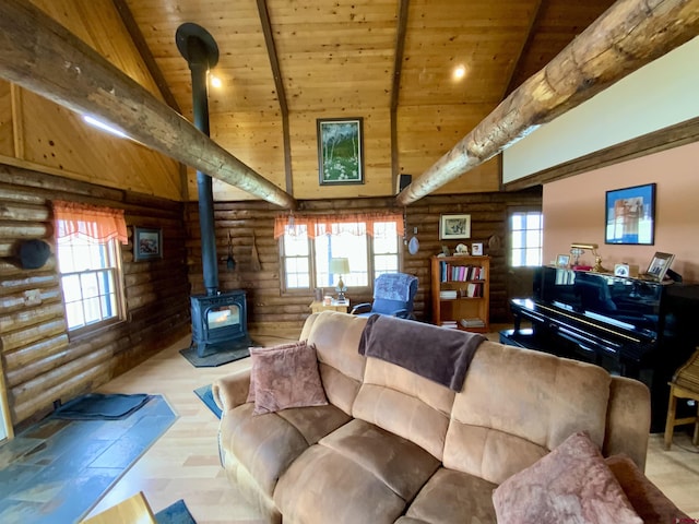 409 Sierra Vista Way, Gunnison, CO 81230 - living area featuring a wood stove, beam ceiling, wooden ceiling, high vaulted ceiling, and rustic walls