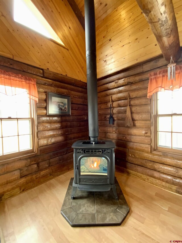 409 Sierra Vista Way, Gunnison, CO 81230 - room details with wood ceiling, a wood stove, log walls, and wood finished floors