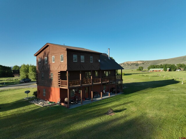 409 Sierra Vista Way, Gunnison, CO 81230 - rear view of house featuring a patio, a deck with mountain view, a yard, and log siding