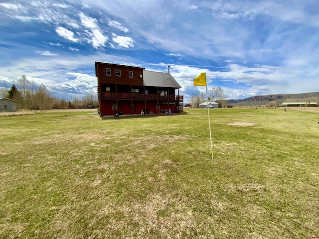 409 Sierra Vista Way, Gunnison, CO 81230 - back of property with a lawn, a deck with mountain view, and metal roof