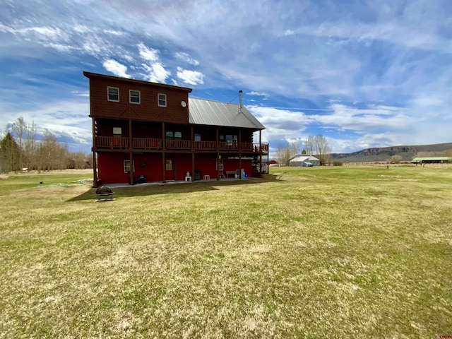 409 Sierra Vista Way, Gunnison, CO 81230 - rear view of house featuring a deck with mountain view, a yard, and metal roof