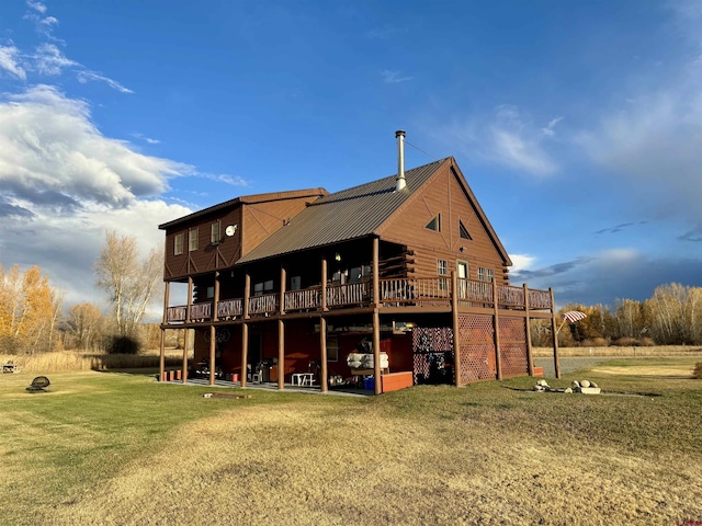 409 Sierra Vista Way, Gunnison, CO 81230 - back of house featuring a lawn, a deck, metal roof, and log siding