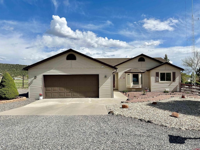 single story home with an attached garage and driveway