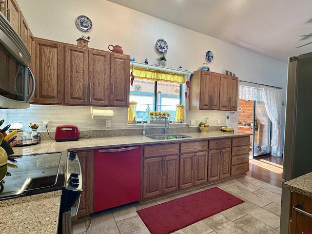 kitchen with a sink, dishwasher, electric stove, stainless steel microwave, and tasteful backsplash