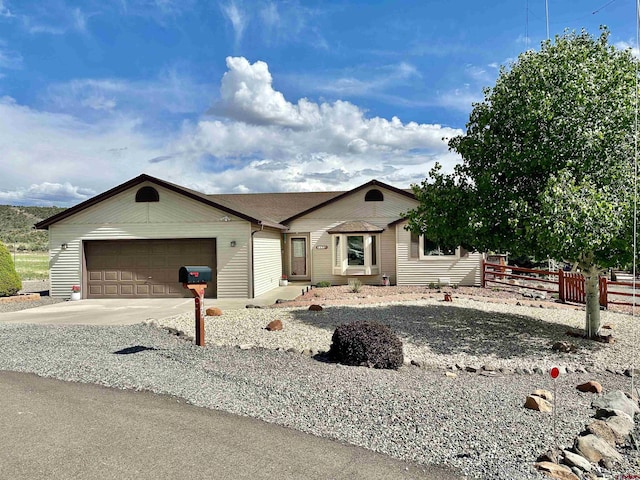 single story home featuring fence, concrete driveway, and a garage