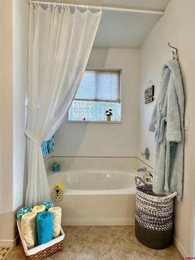 bathroom featuring tile patterned flooring and a bath