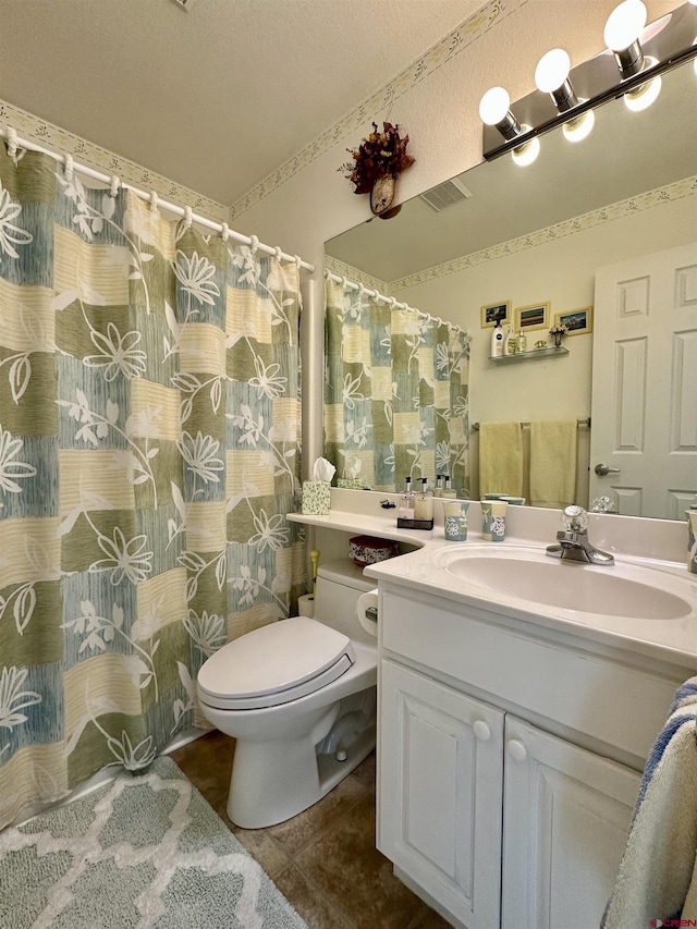 full bathroom featuring vanity, a textured ceiling, visible vents, and toilet