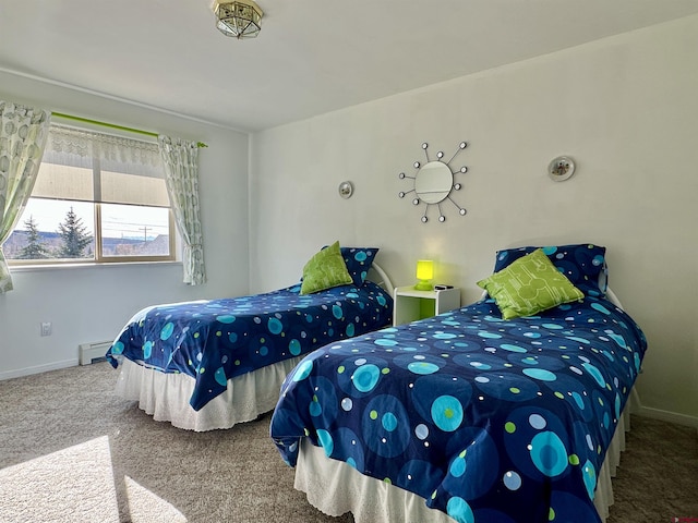 carpeted bedroom featuring baseboards and a baseboard heating unit