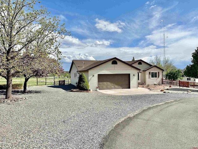 view of property exterior with fence, concrete driveway, and a garage