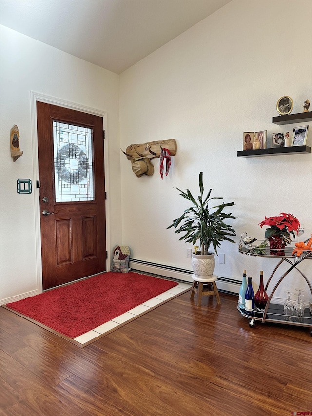 entrance foyer featuring baseboards, a baseboard heating unit, and wood finished floors