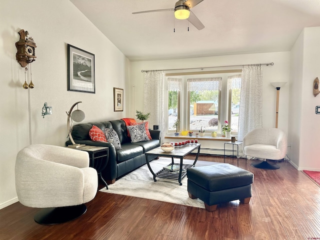 living area featuring baseboards, a ceiling fan, wood finished floors, and vaulted ceiling