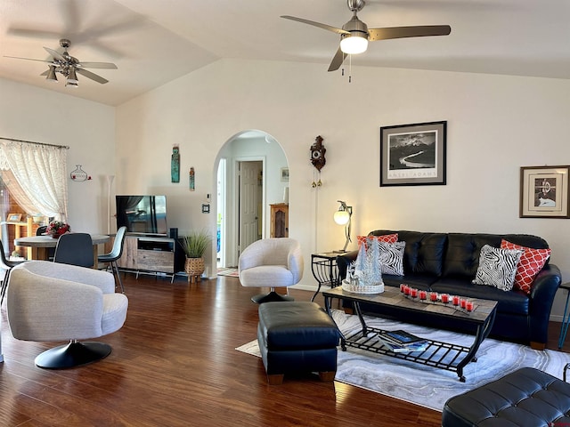 living room featuring a ceiling fan, arched walkways, vaulted ceiling, and wood finished floors