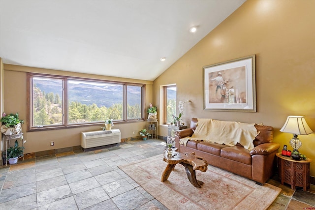 living room with baseboards, vaulted ceiling, recessed lighting, and stone tile floors