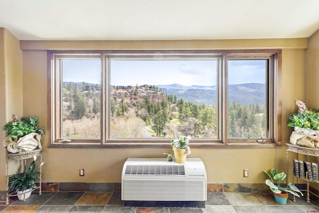 room details featuring an AC wall unit and a mountain view