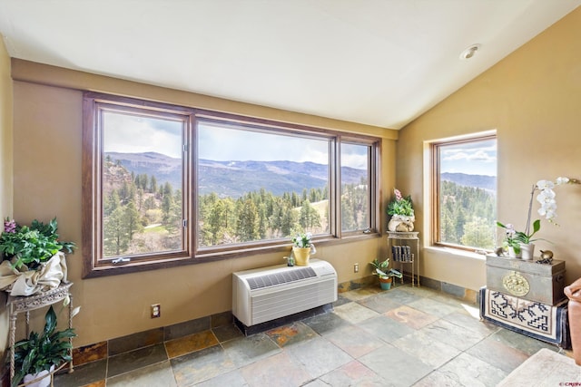 interior space featuring a mountain view, a wall unit AC, and a wealth of natural light