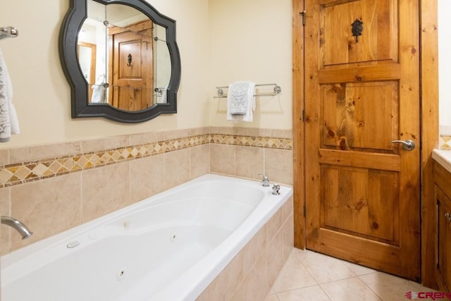bathroom featuring tile patterned floors, a whirlpool tub, and vanity