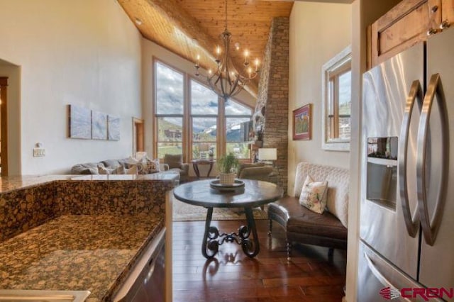 interior space featuring an inviting chandelier, wooden ceiling, wood finished floors, and a towering ceiling